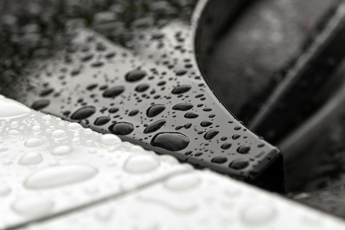 Water droplets beading on paint