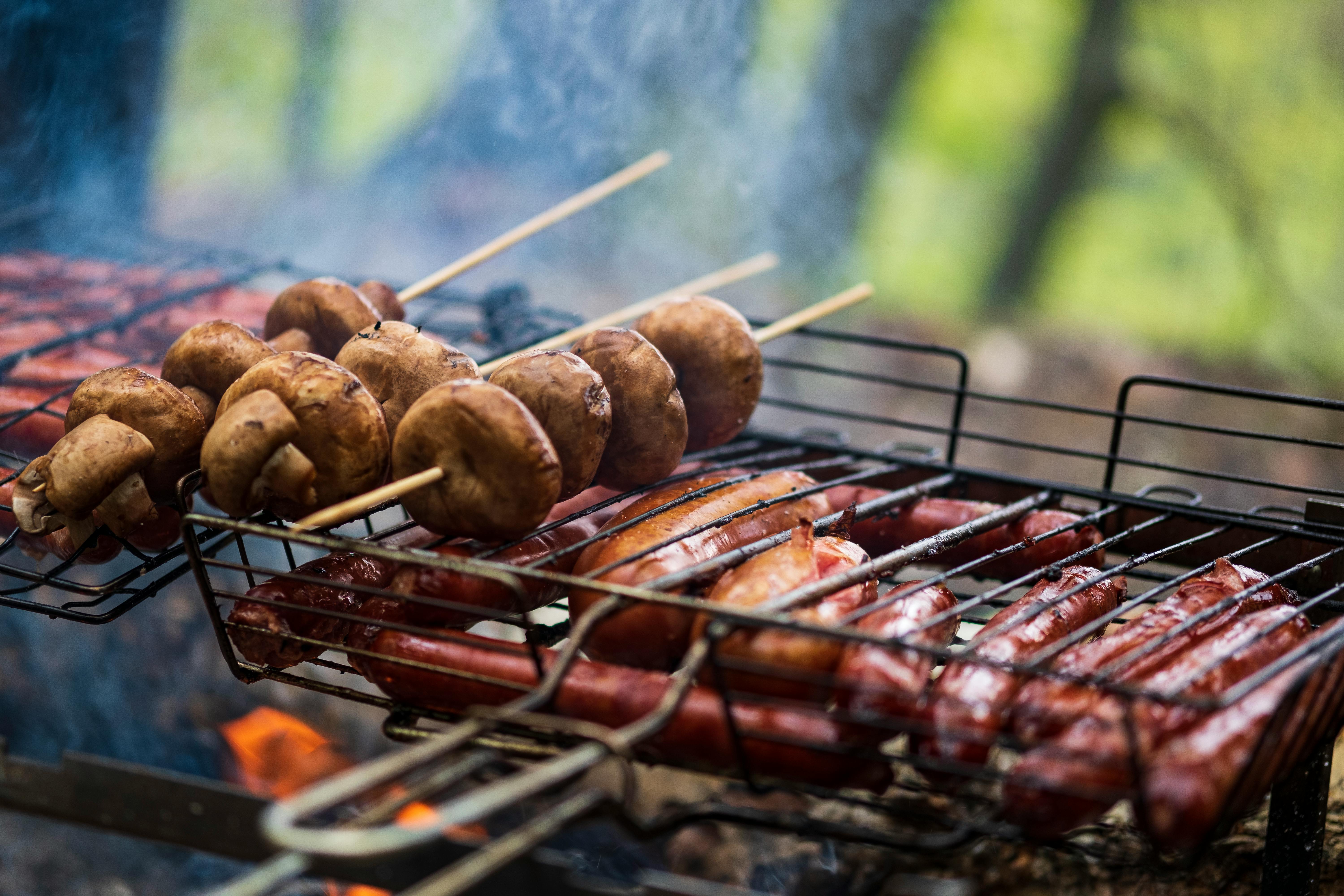 bbq in the garden grilling sausages on barbecue grill bavarian sausages barbecue cooking cooking food on an open fire