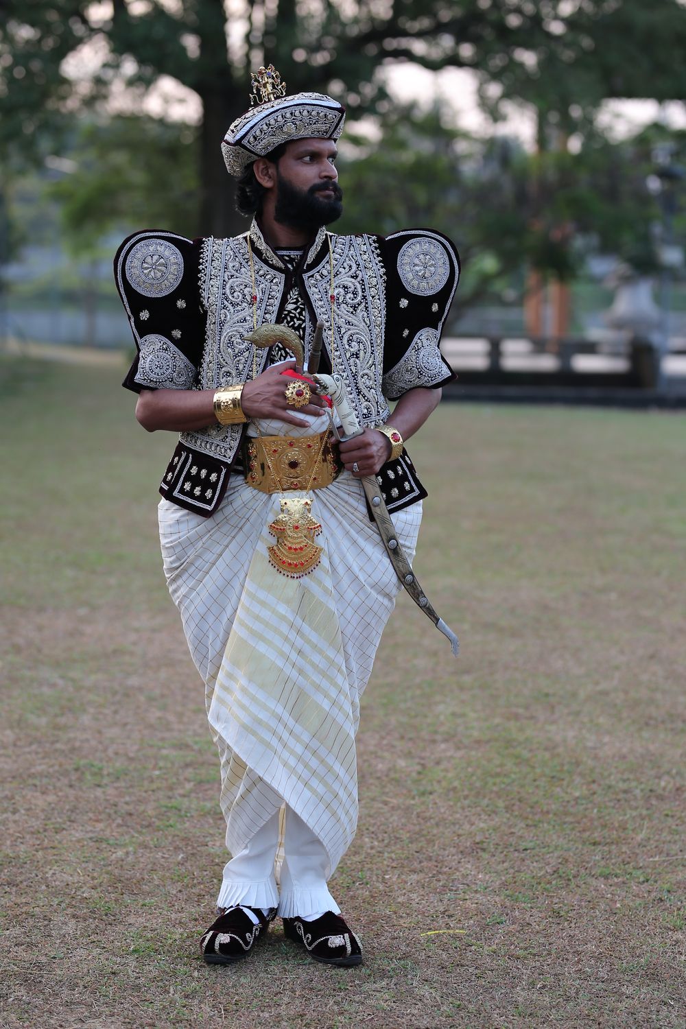 Groom in traditional Kandyan bridegroom attire posing outdoors