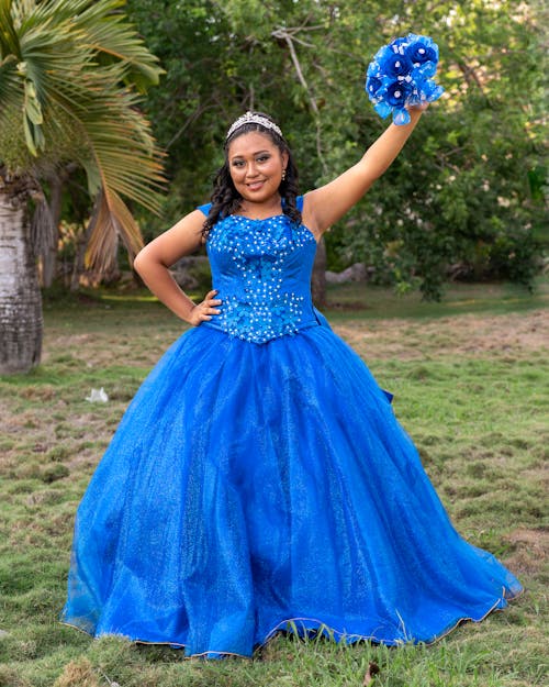 Smiling Brunette Woman in Blue Dress