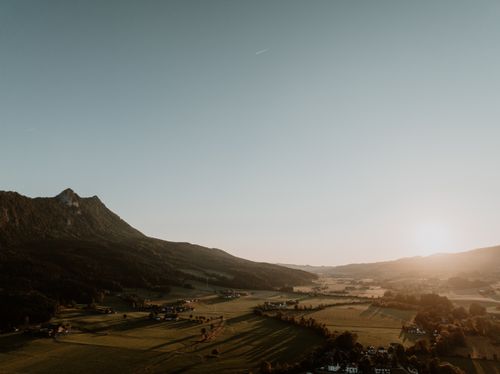 Free Capture of Mondsee's landscape in Upper Austria at sunset, showcasing vast fields and mountains. Stock Photo