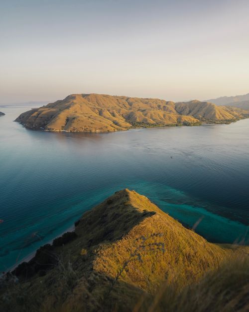 Free Dramatic aerial shot of Komodo Island's coastline during sunset, showcasing the unique landscape. Stock Photo