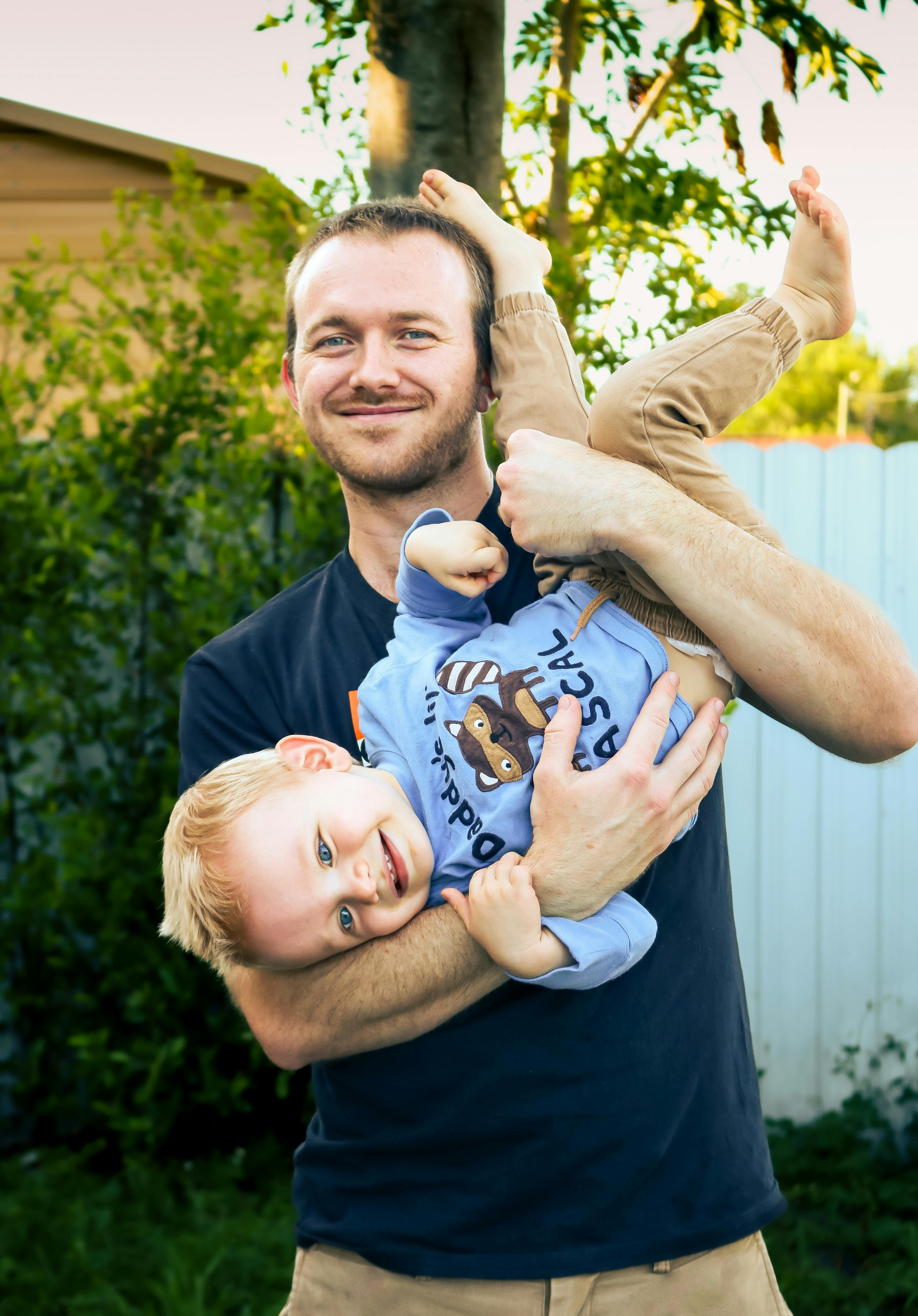 smiling father holding son