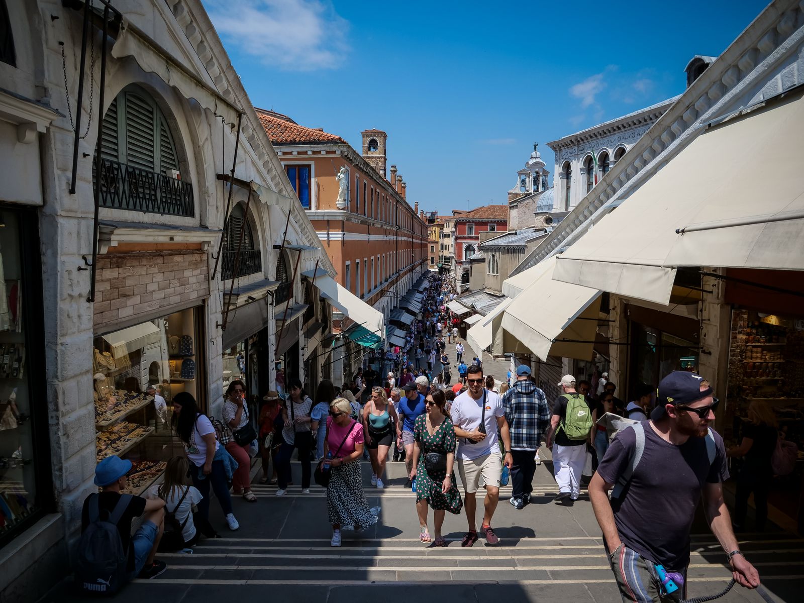 Crowds crossing Rialto Bridge over the Grand Canal in Venice