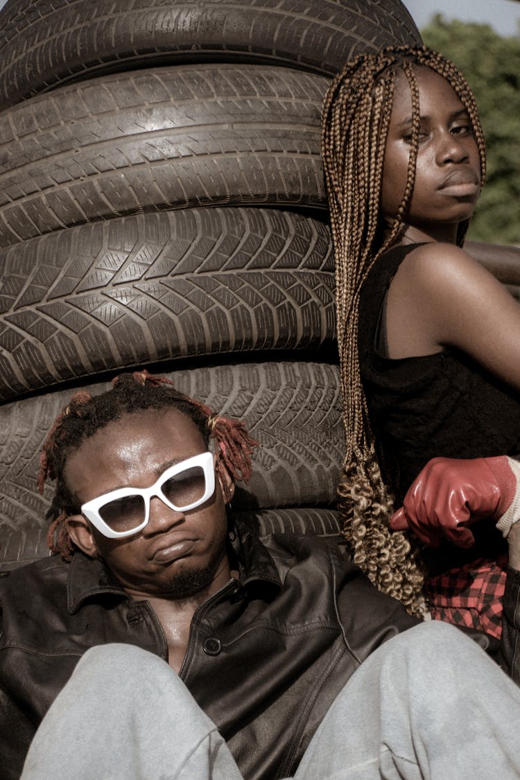 Man And Woman By Stack Of Tires