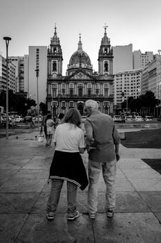 Elderly couple explores Candelária Church in Rio de Janeiro, Brazil. Black and white photo captures the moment.