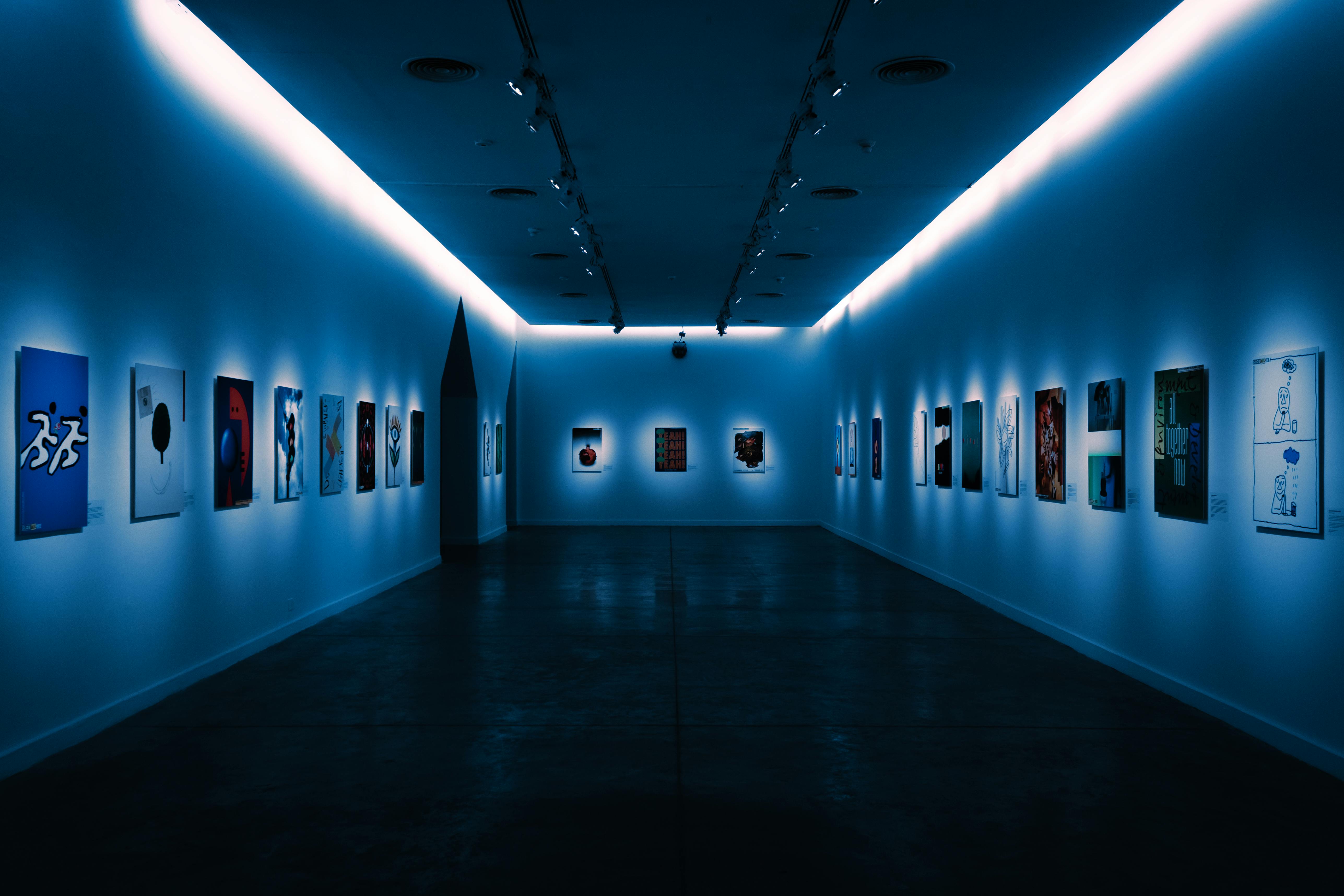 Contemporary artworks displayed in a dimly lit modern gallery space in Buenos Aires.