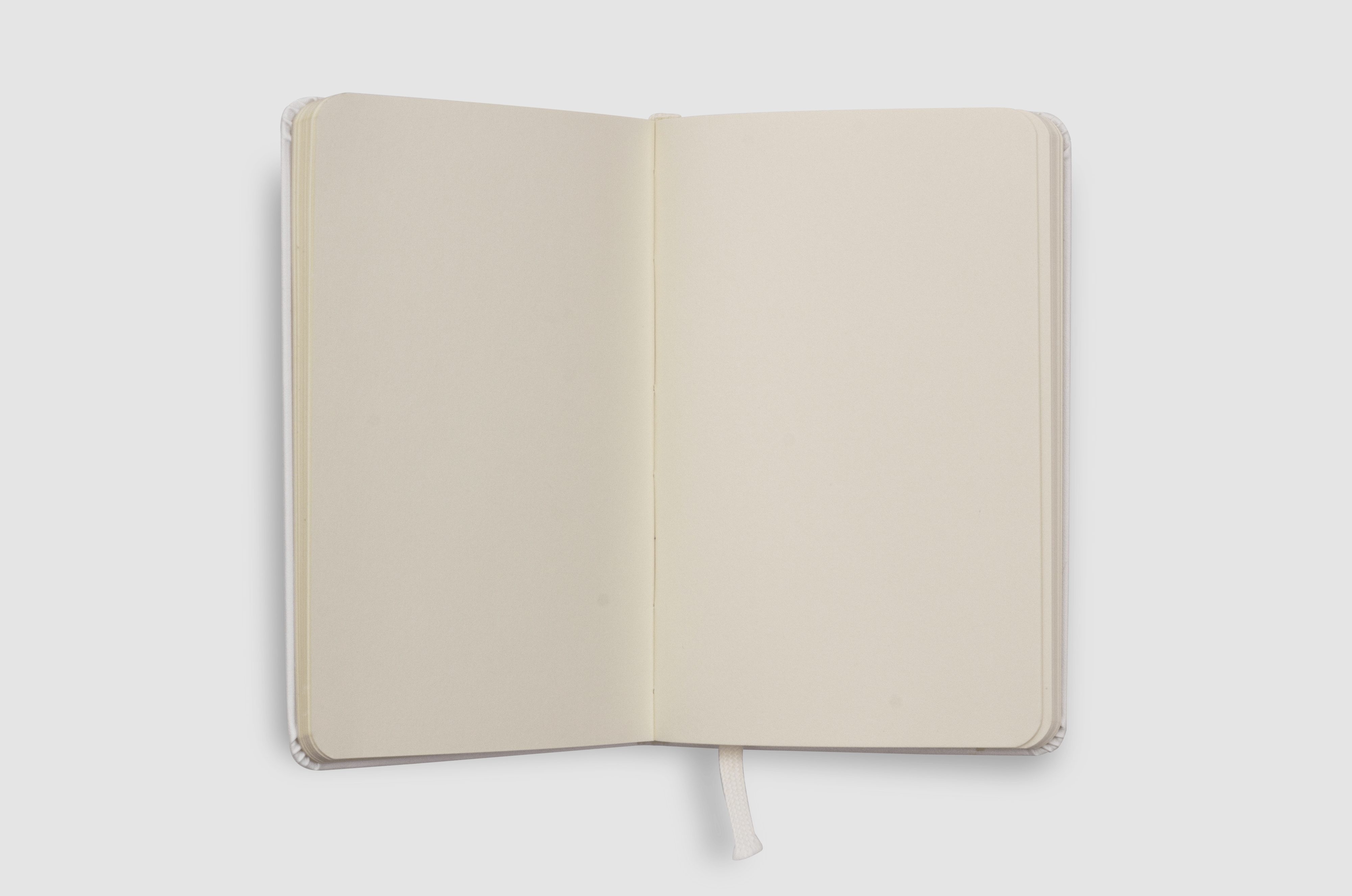 Minimalist open notebook with blank pages on a white background, ideal for design mockups.