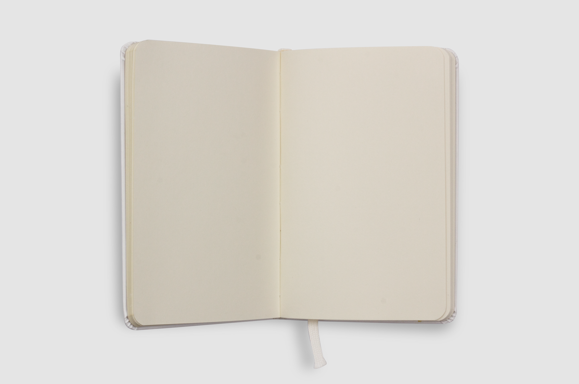 Minimalist open notebook with blank pages on a white background, ideal for design mockups.