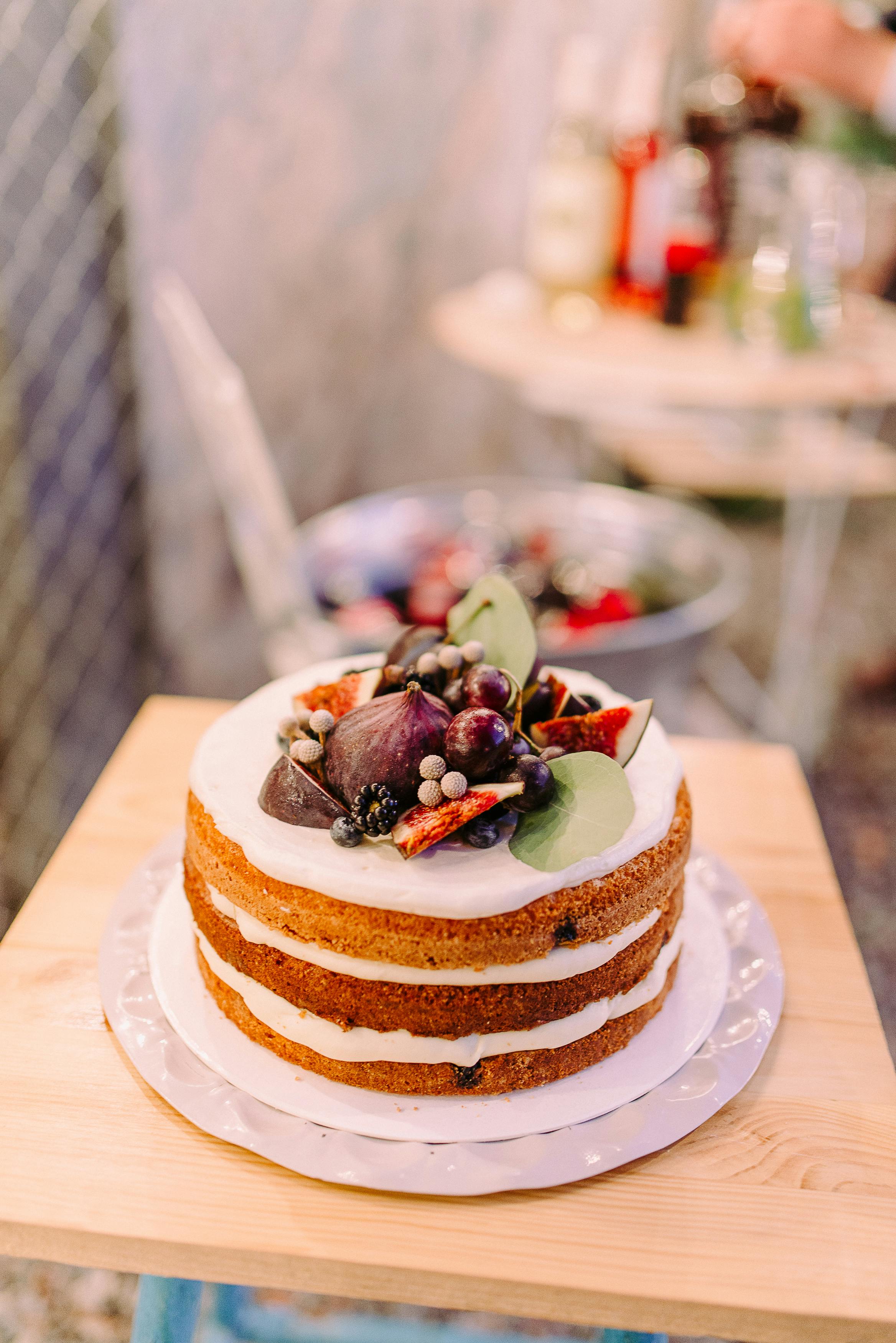 white icing covered cake in bokeh photography