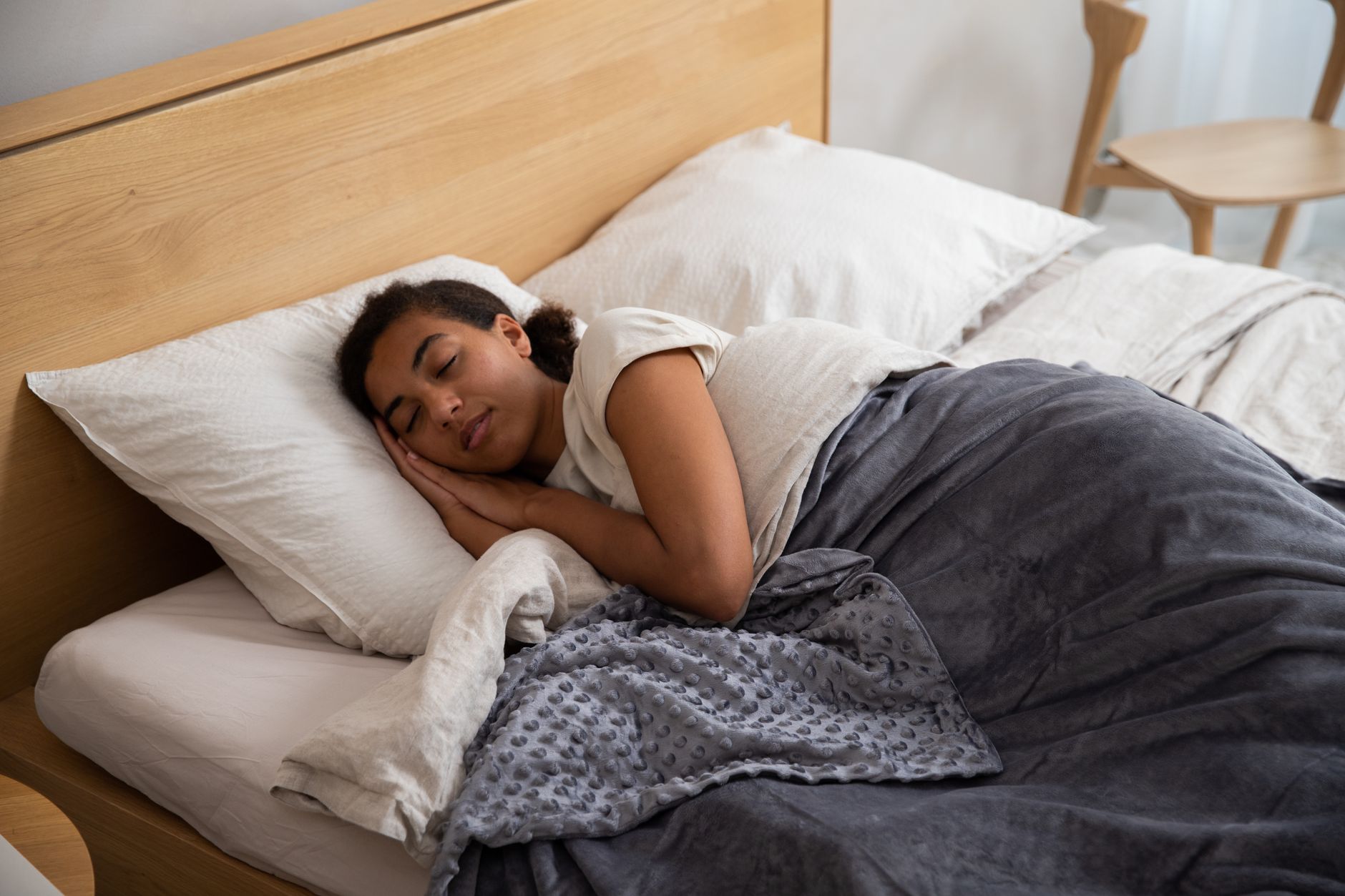 Indian adult practicing breathing exercises before sleeping in a calm bedroom at night