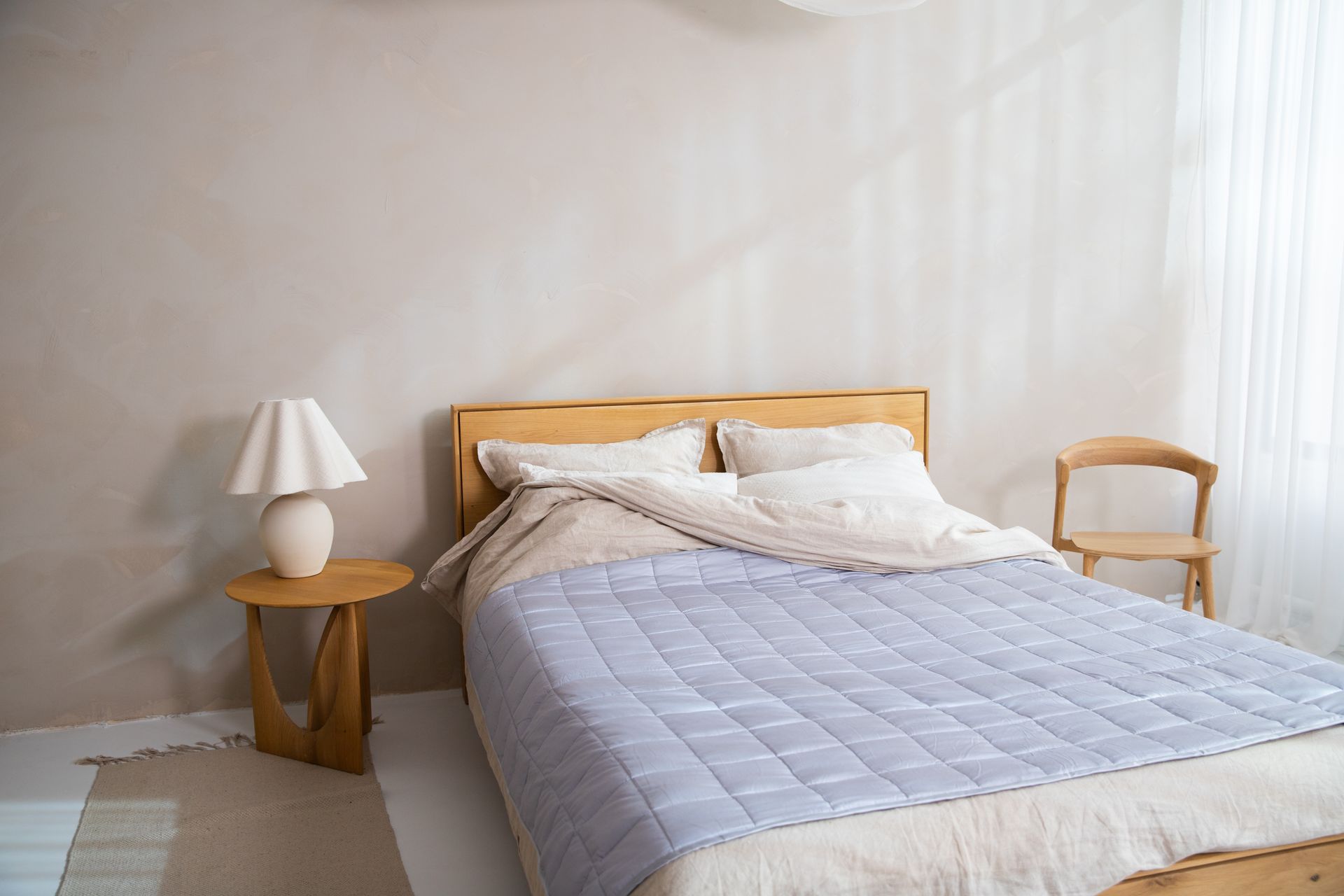 Contemporary bedroom design with wooden furniture and soft natural lighting.
