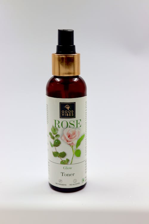 Glass Bottle with a Rose Glow Toner on a White Background