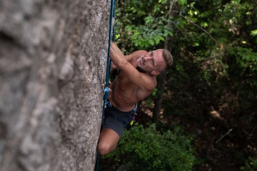 Free A focused man rock climbing in Ko Tao, Thailand, showcasing adventure and skill. Stock Photo