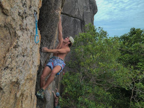 Toplss Man Rock Climbing
