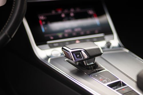 Free Close-up of a sleek luxury car's gearshift and control panel. Stock Photo
