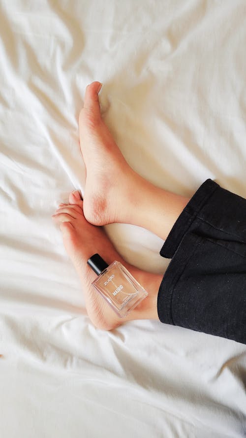 Vial of Perfume on Woman Feet