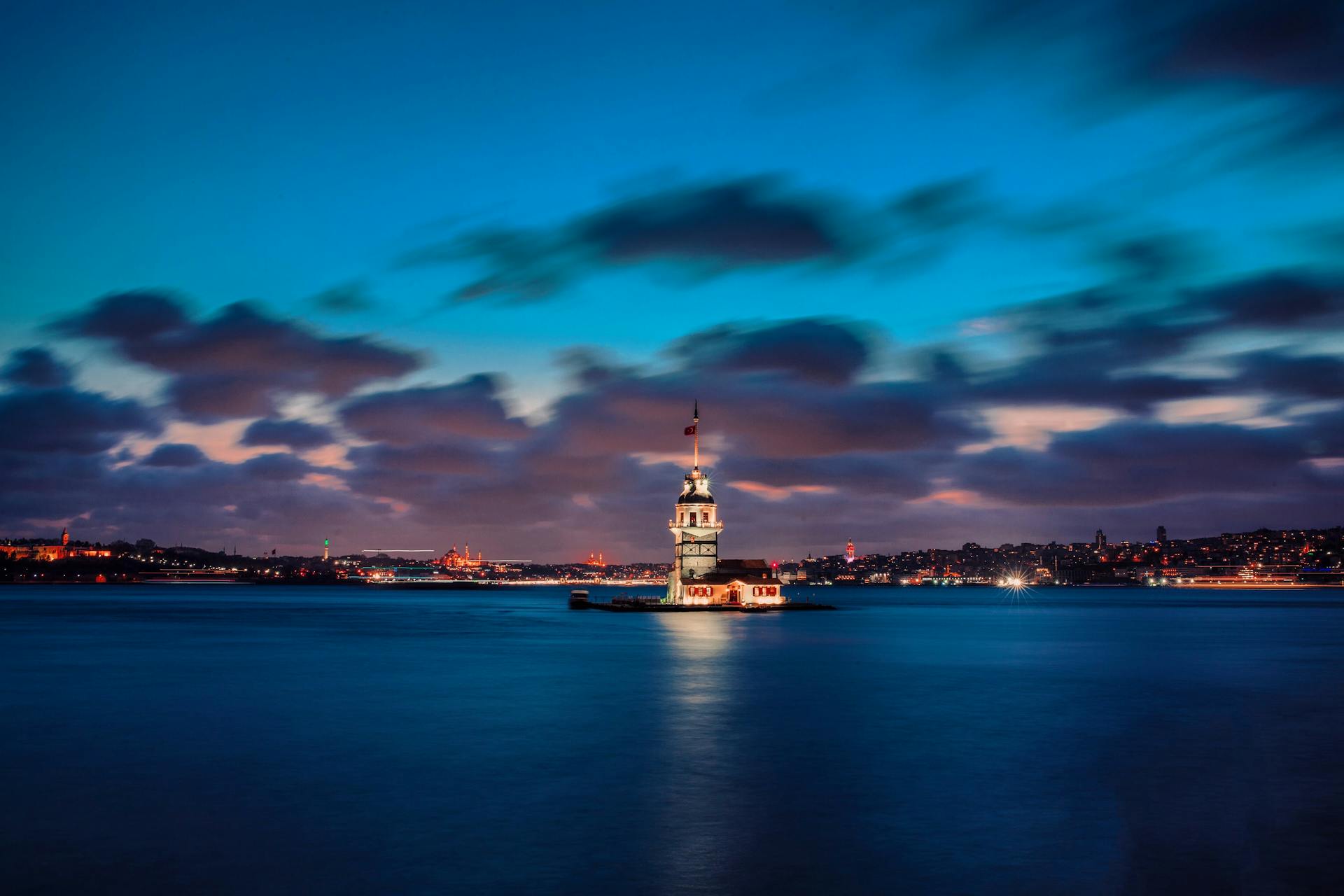 Lighthouse on Island on Bay at Night
