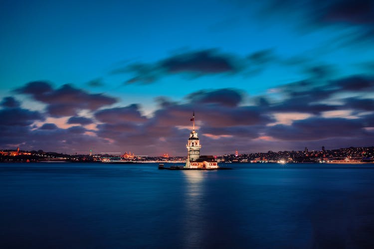 Lighthouse On Island On Bay At Night