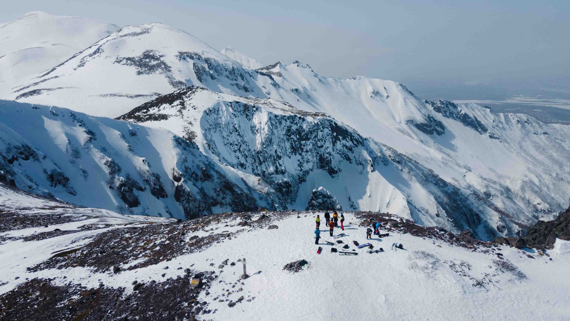 A stunning winter scene with adventurers on snowy ridges in Hokkaido, Japan.
