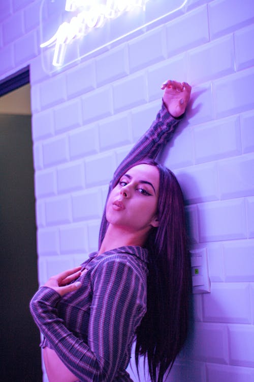 Woman Posing by White Brick Wall