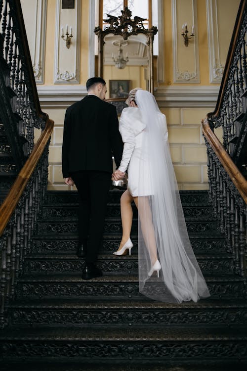 Back View of Bride and Groom Walking Up the Stairs