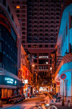 Dynamic urban nightscape of bustling Ho Chi Minh City street, showcasing atmospheric lighting.