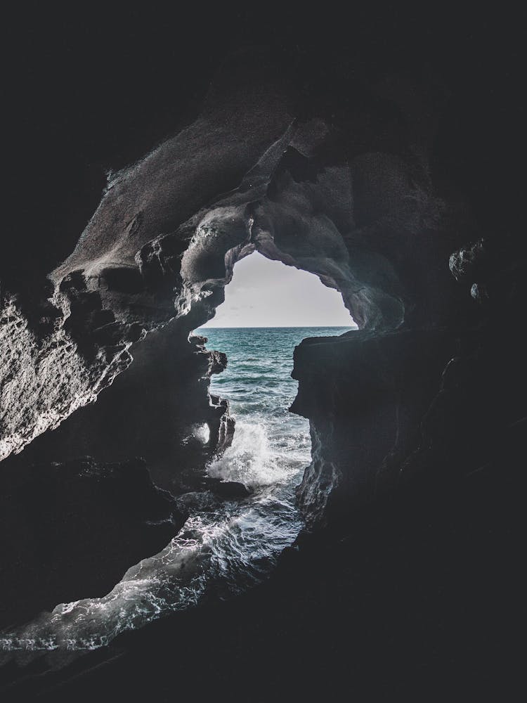 Gray Cave Near Body Of Water