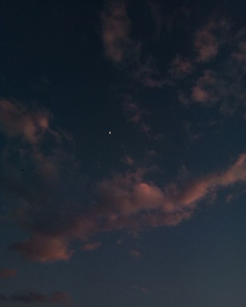 Free A serene dusk sky with clouds and a crescent moon over Abbottabad, Pakistan. Stock Photo