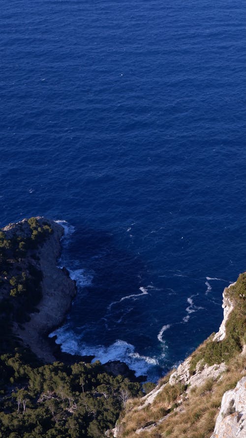 High Angle Shot of Waves on a Rocky Shore 