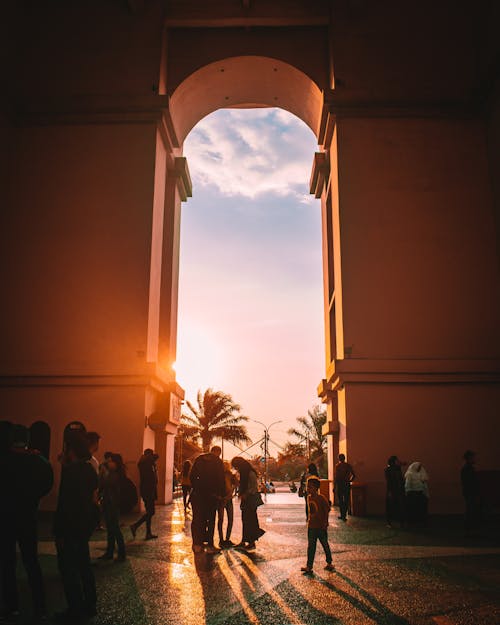 People Standing on Concrete Arch