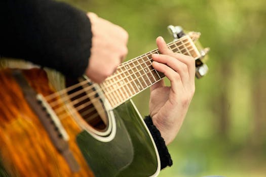 Detailed view of hands strumming and fingering a guitar, capturing musical expression.