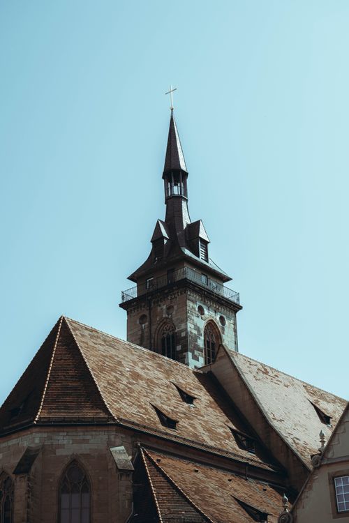Free A beautiful church spire in Stuttgart, Germany, reaching into a clear blue sky, showcasing historic architecture. Stock Photo
