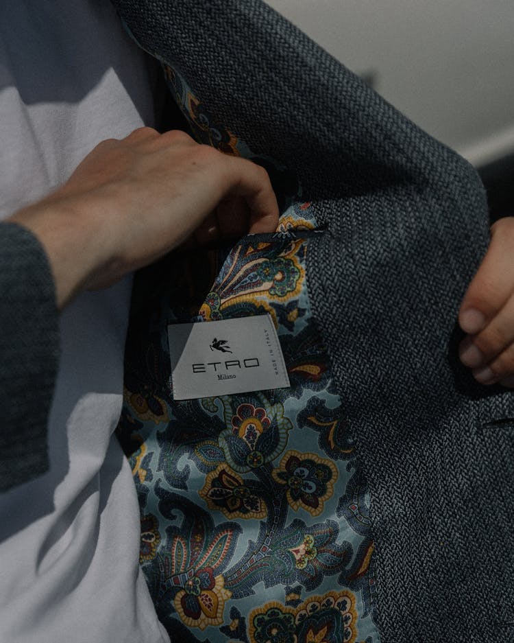 Close-up Of A Man Reaching Into The Pocket Inside His Blazer 