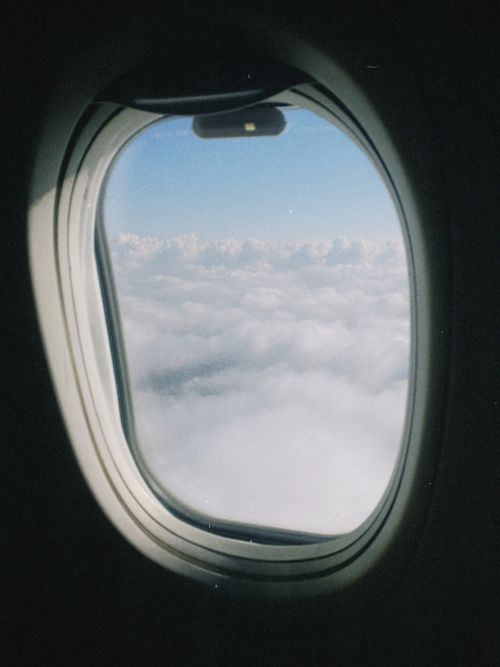 Free Serene view of fluffy clouds from an airplane window, capturing the essence of travel. Stock Photo