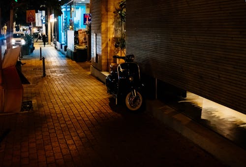 Black Motor Scooter Park Near Building