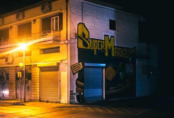 Street art on a shuttered storefront at night — photo by Igor Starkov on Pexels