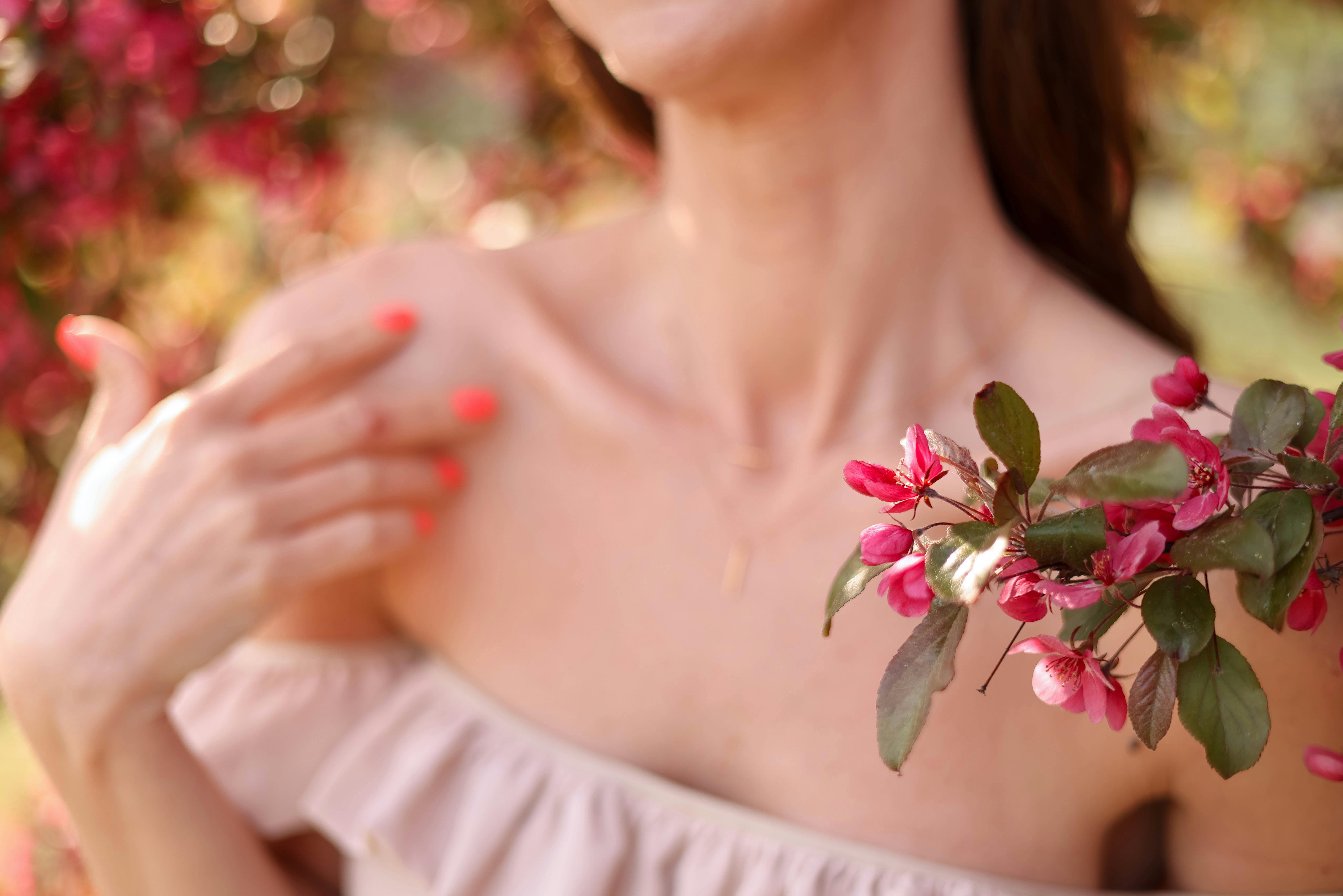 https://images.pexels.com/photos/17224887/pexels-photo-17224887/free-photo-of-woman-in-an-off-shoulder-dress-standing-between-cherry-blossom-branches.jpeg