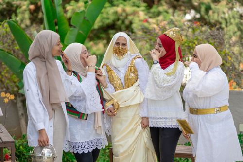 Free A group of smiling women in traditional attire celebrating outdoors in Nabeul, Tunisia. Stock Photo