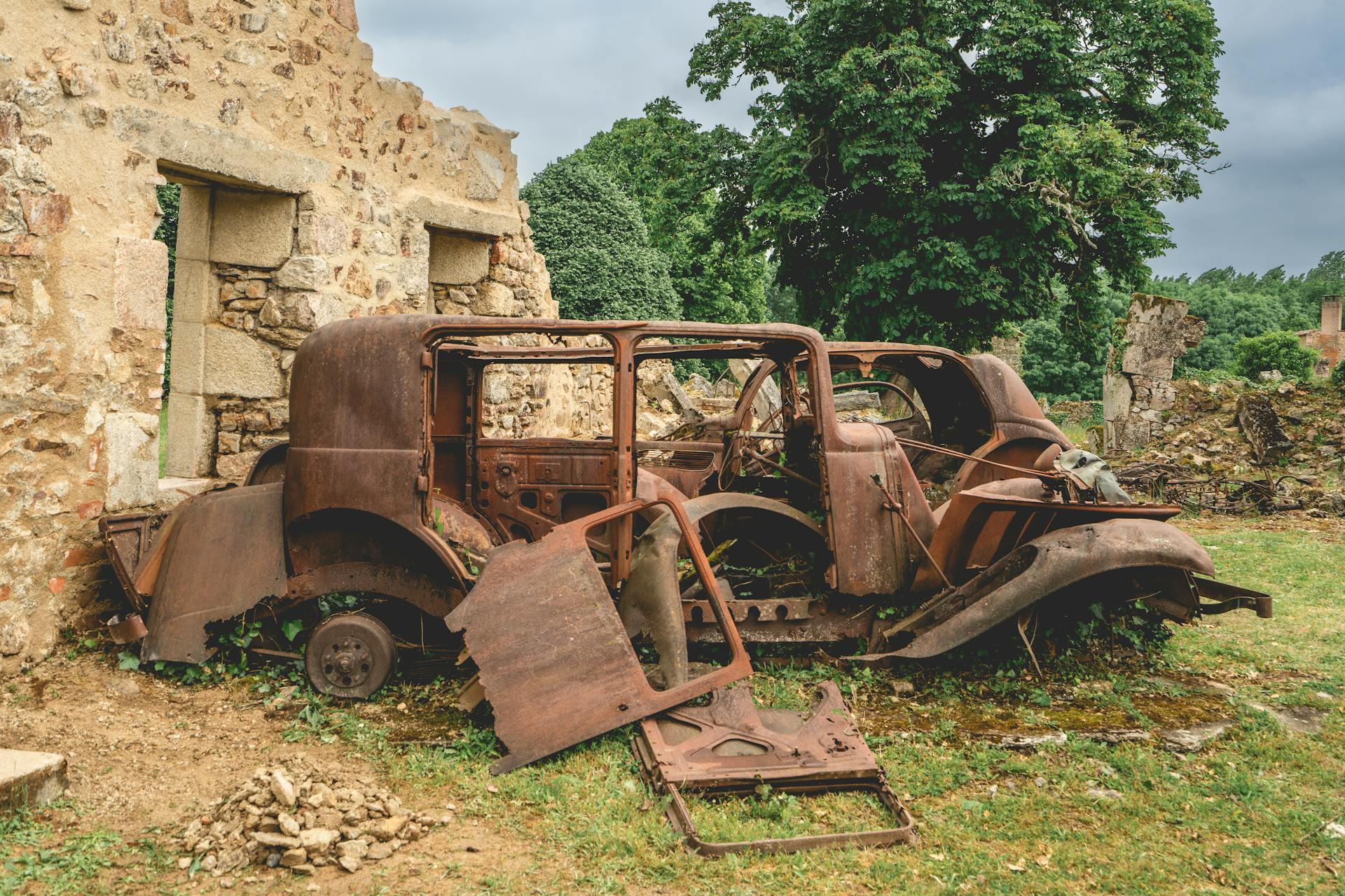 Old rusty cars left behind in Oradour-sur-Gllane, France.