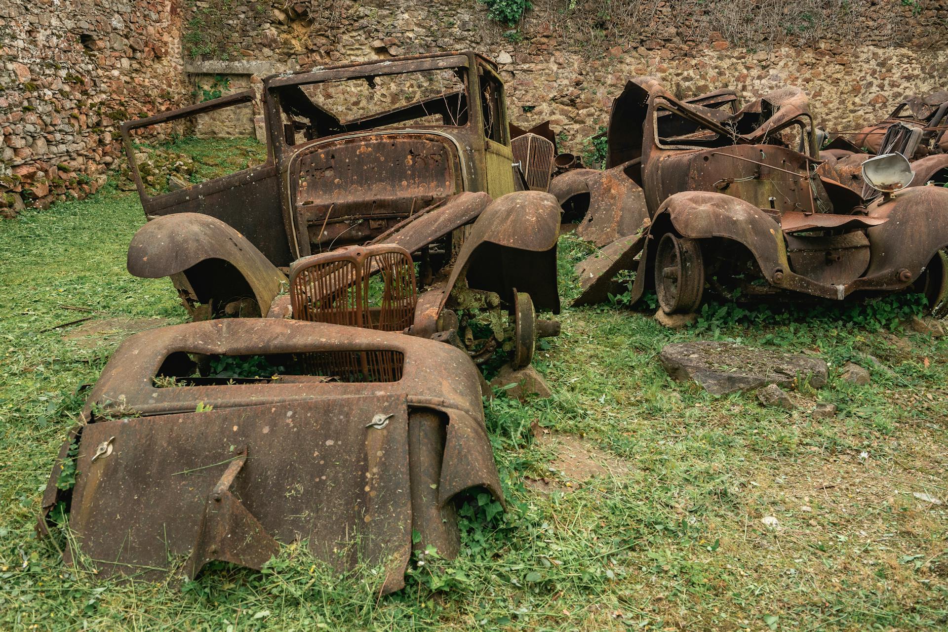 Old rusty cars left behind in Oradour-sur-Gllane, France.