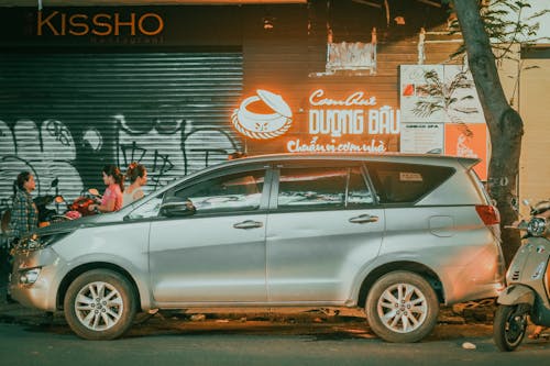 Car Covering Illuminated Facade of Bar