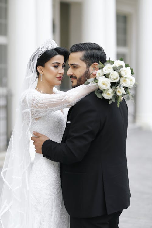 Newlyweds Standing and Hugging