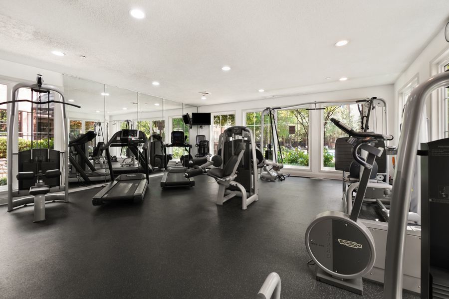 Trainer supporting client during workout