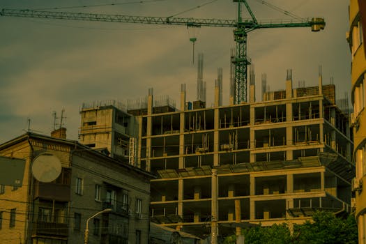 A crane over a modern building under construction in Dnipro, Ukraine.