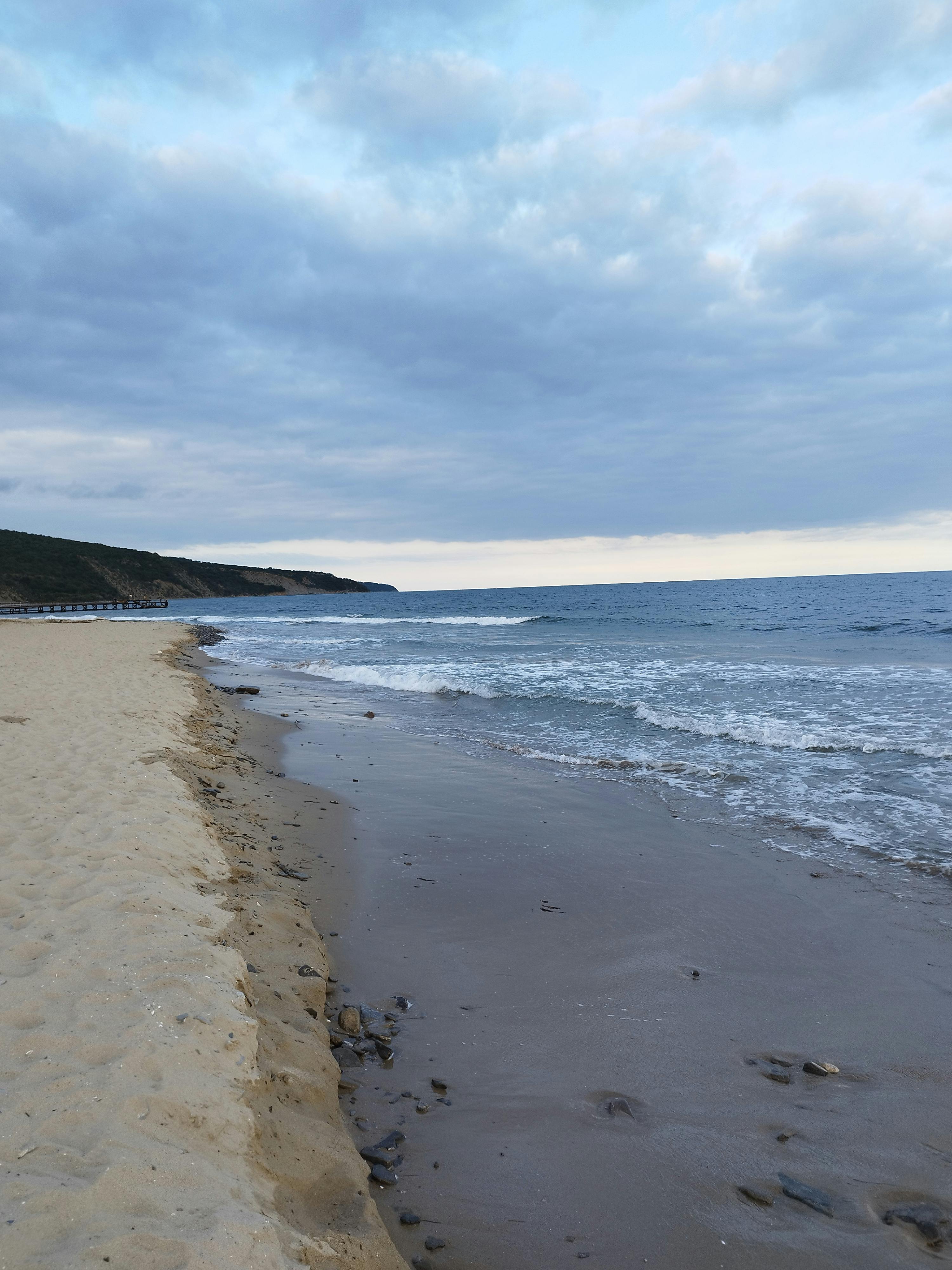 Man walking in a dusty, deserted landscape with guitar