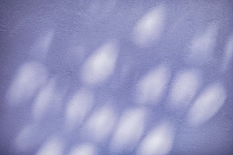 Specks Of Light On Blue Wall