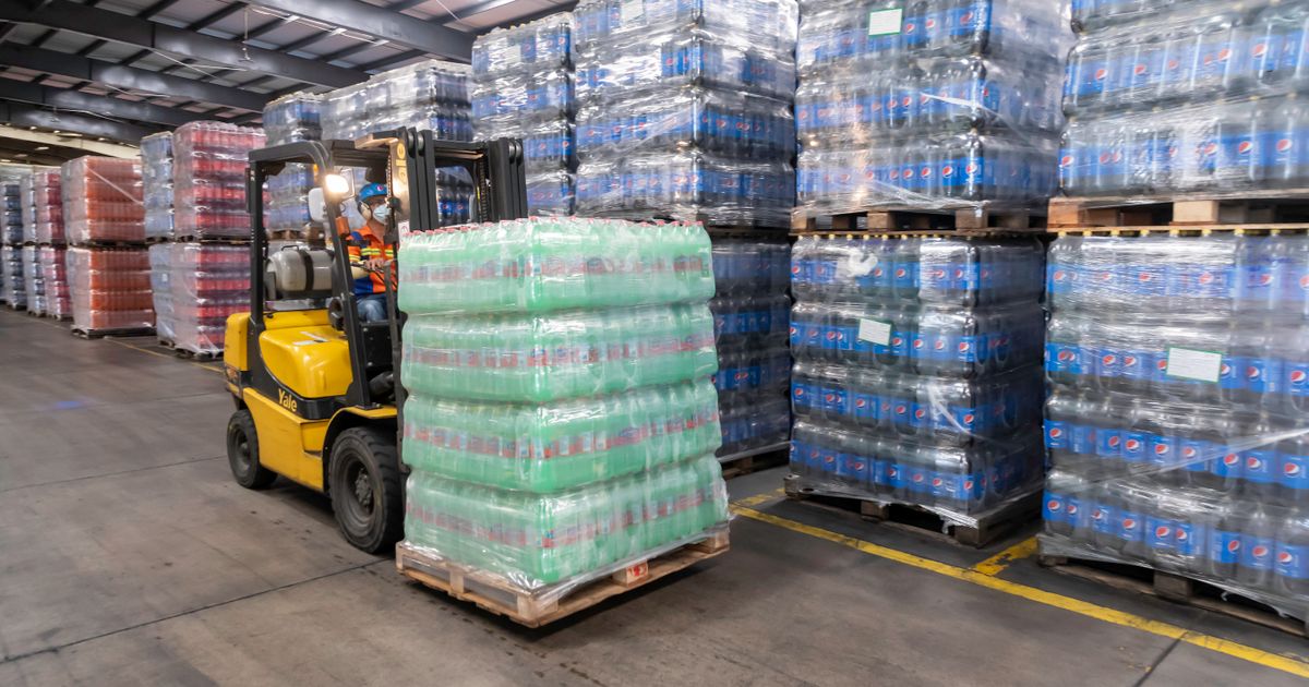 Forklift moving stock in a distributed warehouse