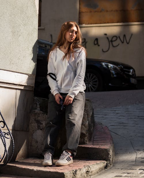 Young Woman in Gray Sweatshirt Posing on Street