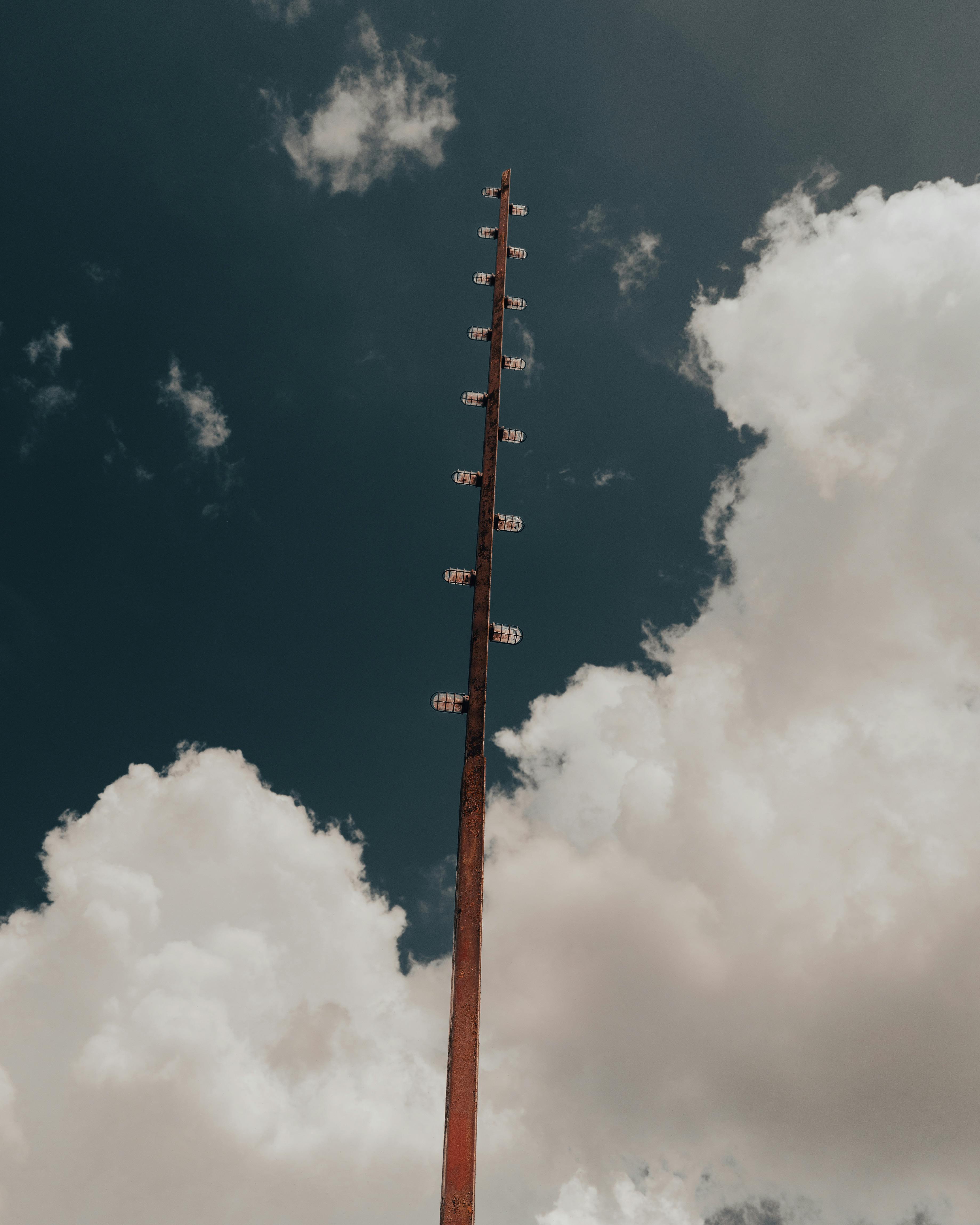 Free Vertical shot of a tall lamp post set against a dramatic cloudy sky in Lakeland, Florida. Stock Photo